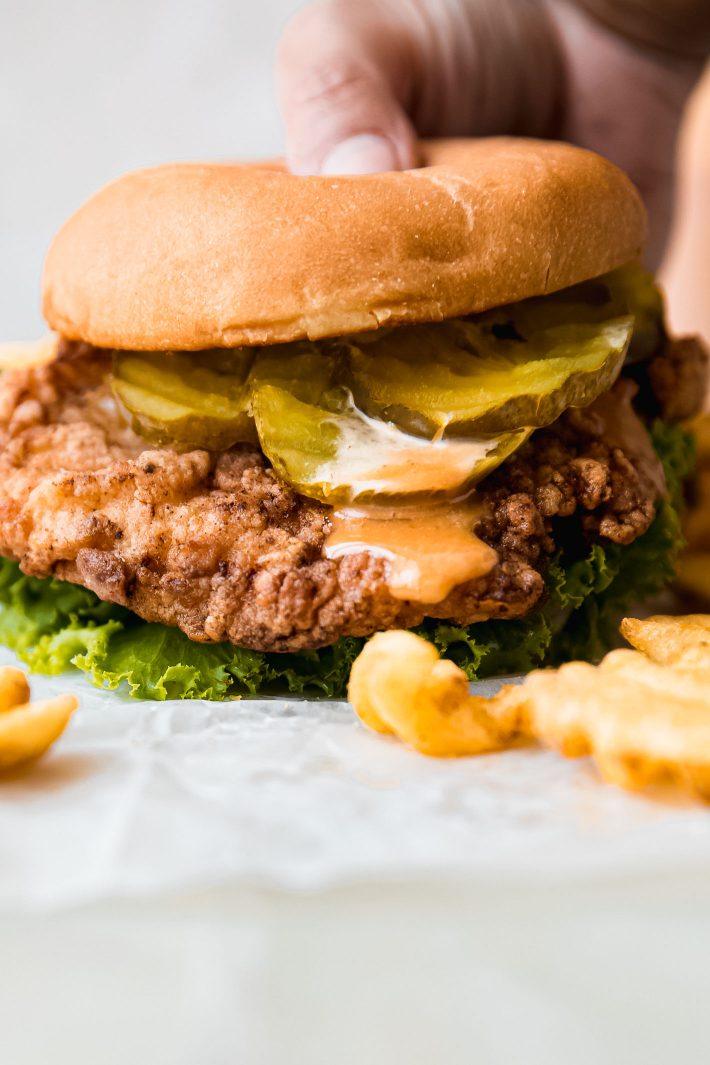 Fried chicken sandwich with pickles and waffle fries