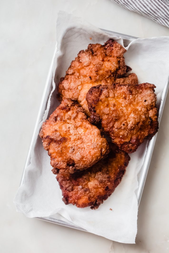 fried chicken breasts on sheet pan lined with paper towel