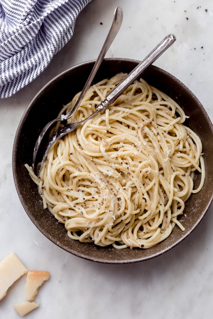bowl of cacio e pepe with fork and spoon