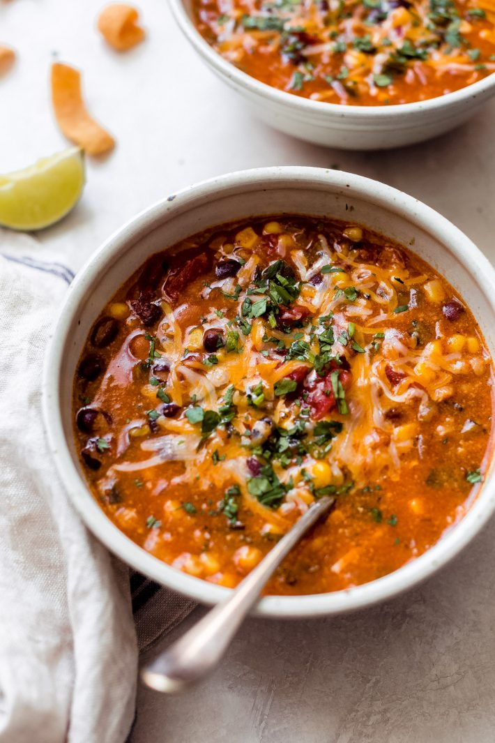 spoon resting in bowl of prepared enchilada soup