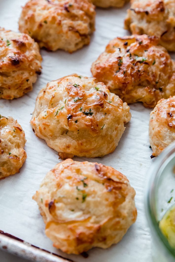 gruyere drop biscuits brushed with parsley butter on parchment
