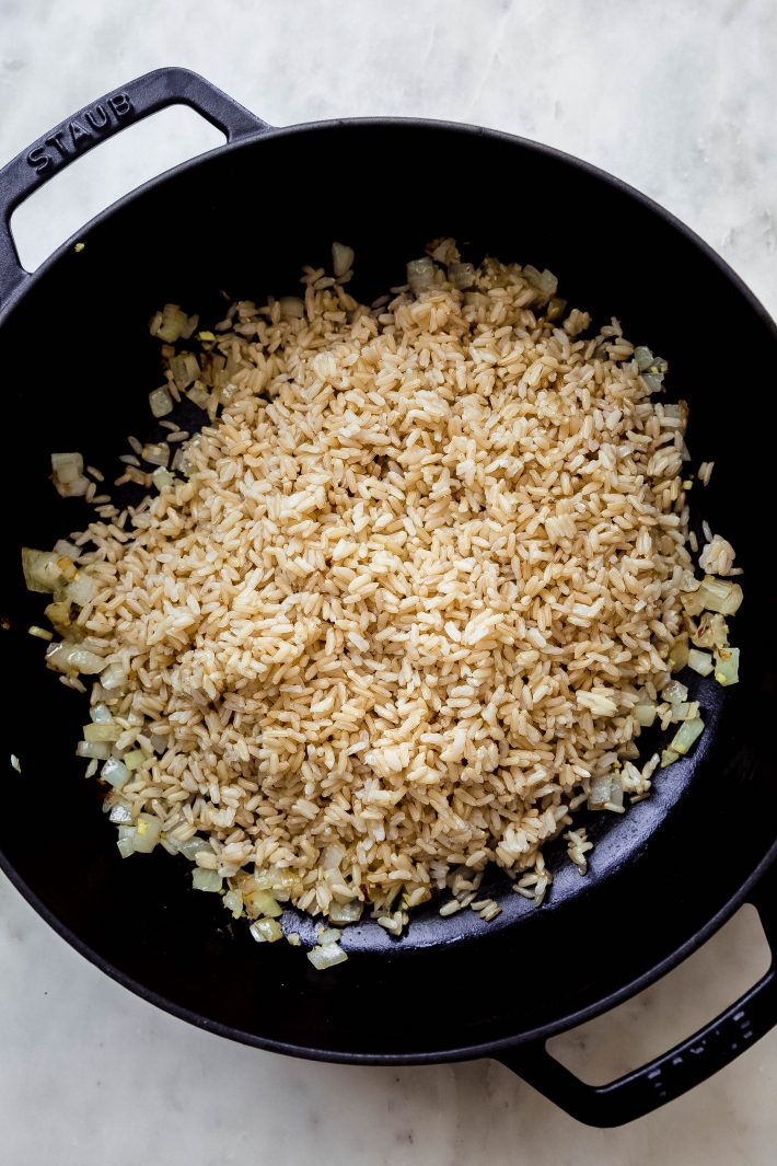 sautéed onions and rice in large cast iron fry pan