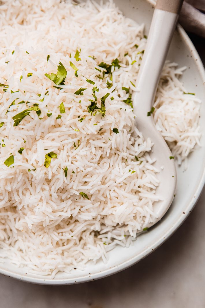fluffy perfect basmati rice in plate with ceramic spoon