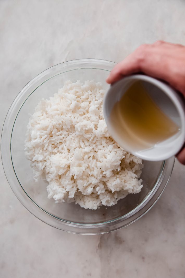 jasmine rice being seasoned with rice vinegar, sugar, and salt mixture