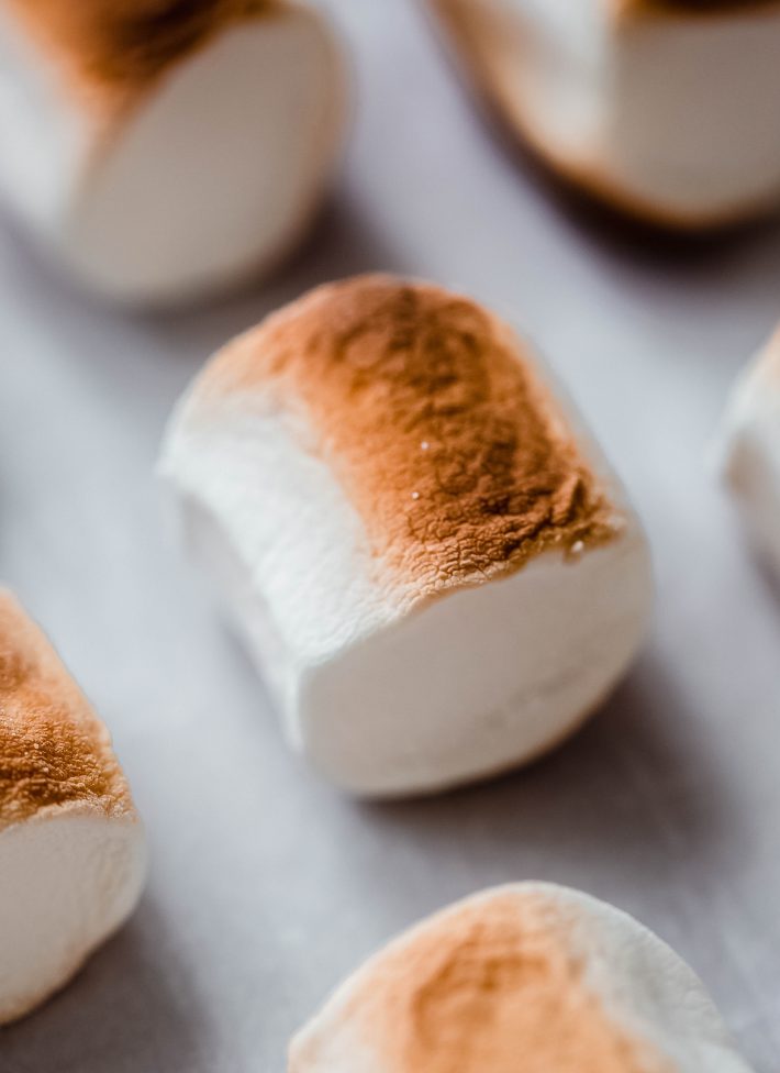 browned marshmallows on parchment-lined baking sheet