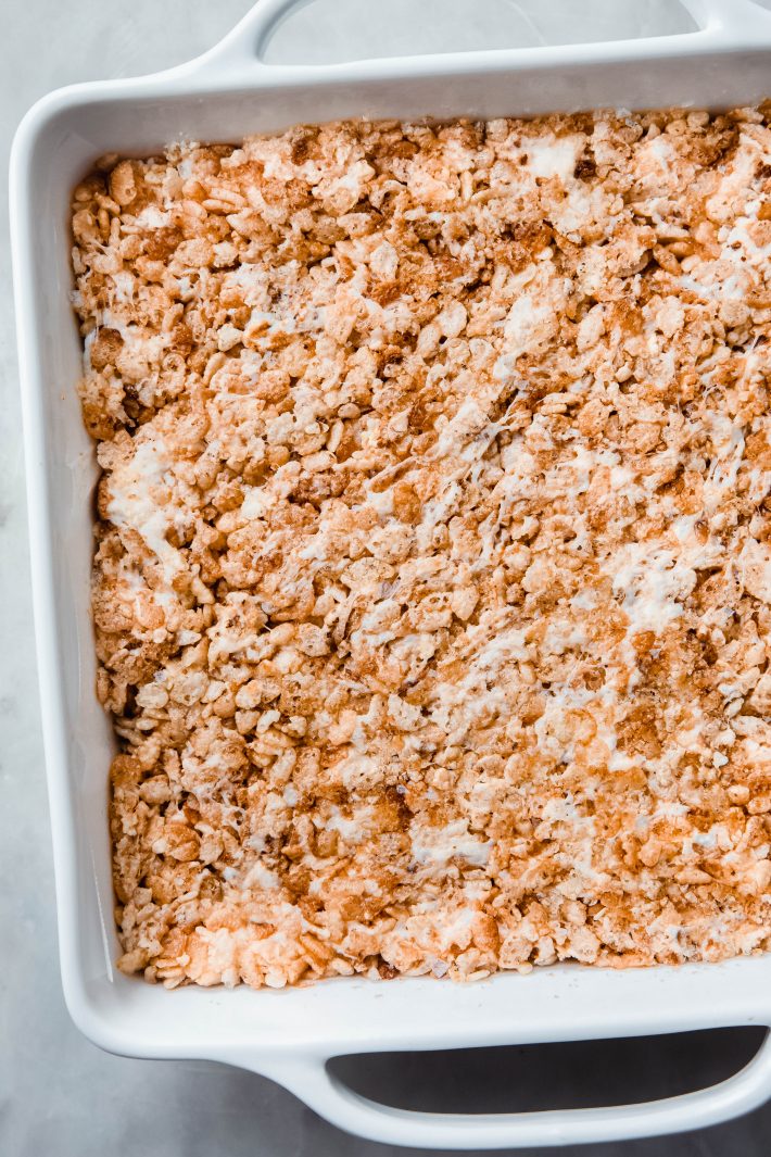 pressed Rice Krispies Treats in pan, ready to be portioned