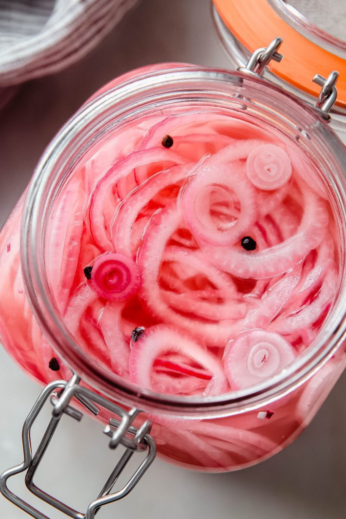 jar with pickled onions and black peppercorn