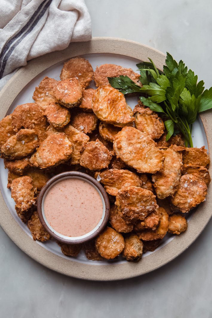 fried pickles on plate with remoulade and parsley
