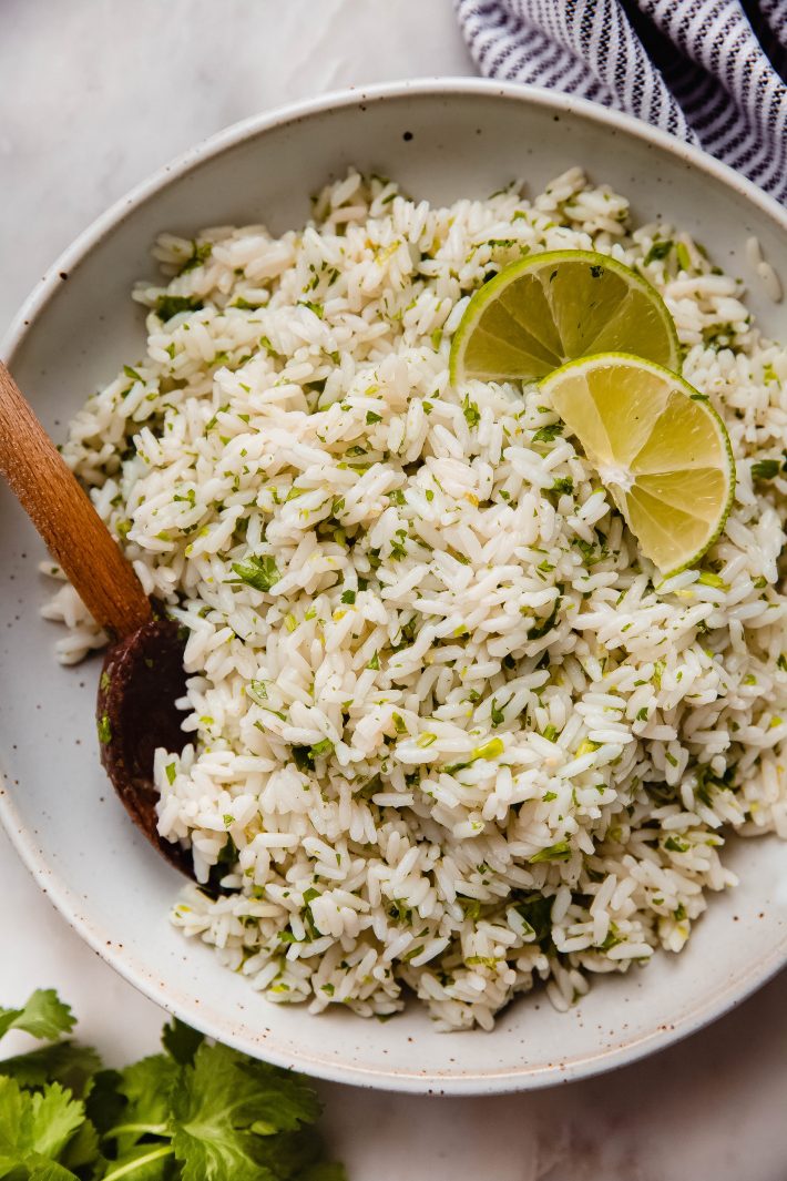 speckled bowl with cilantro lime rice and wooden spoon