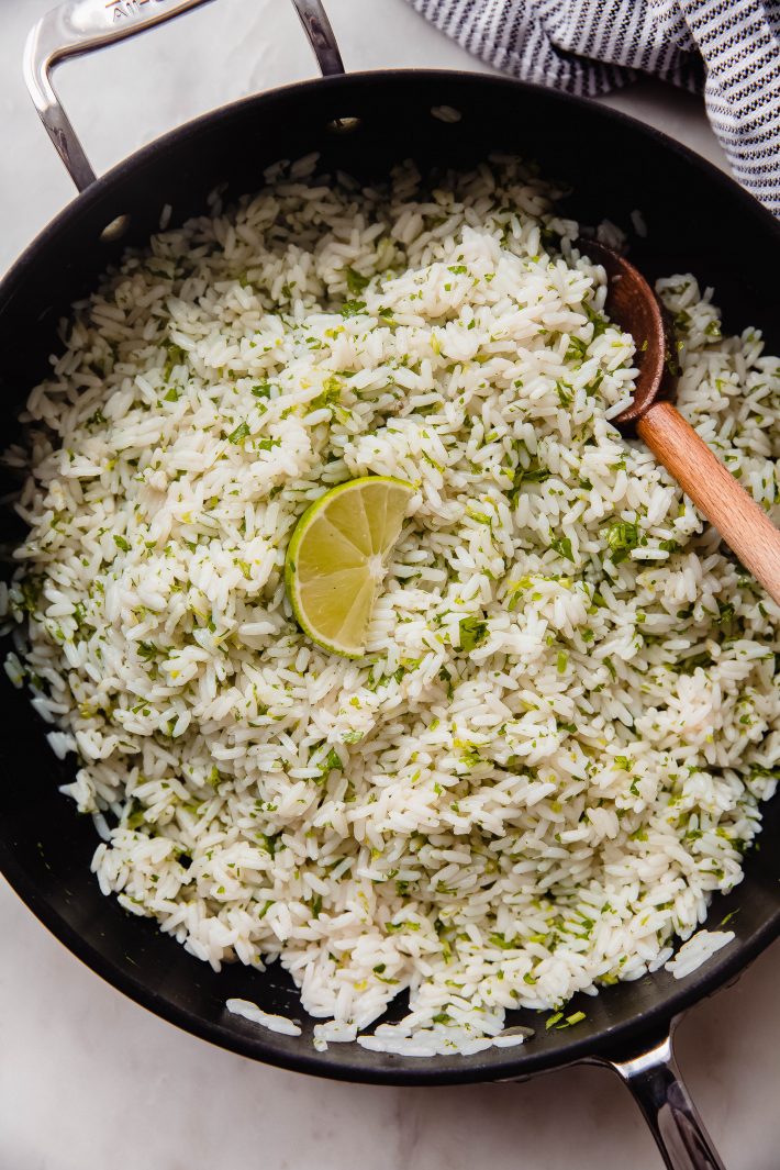 rice mixed with lime juice, zest, and cilantro in saute pan