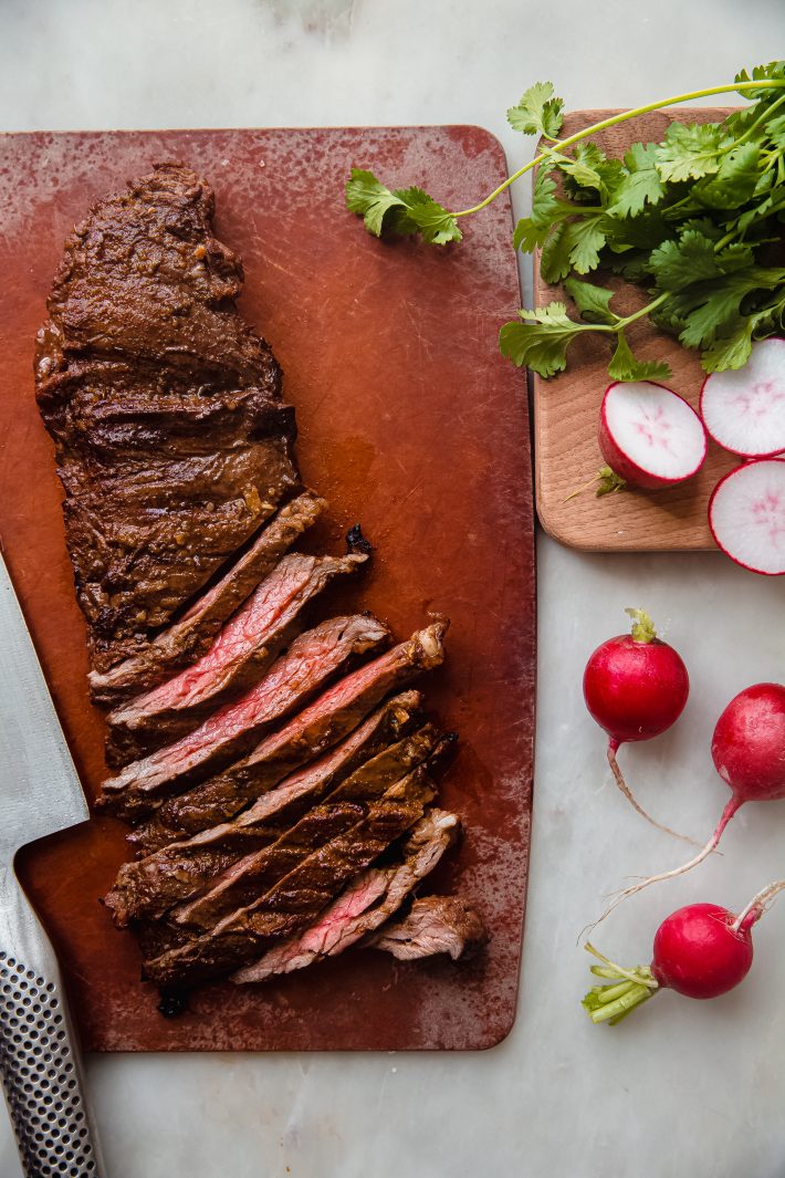 sliced carne asada steak on cutting board