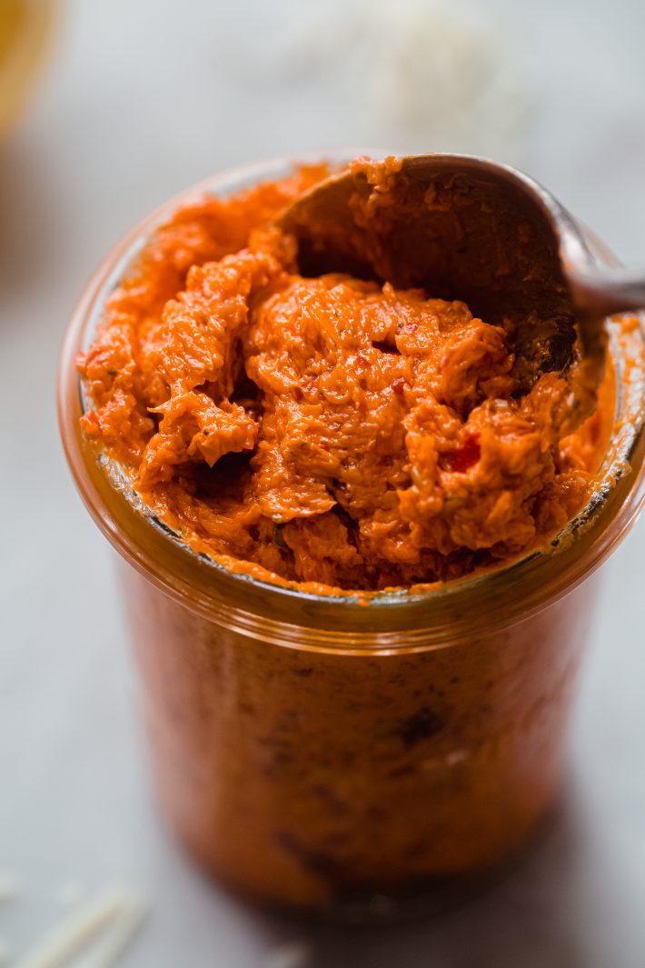 whipped calabrian chili butter in glass container with spoon