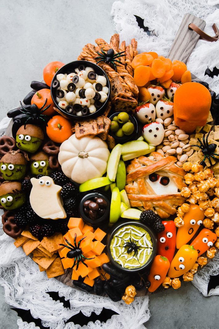 halloween charcuterie board on white netting with bats