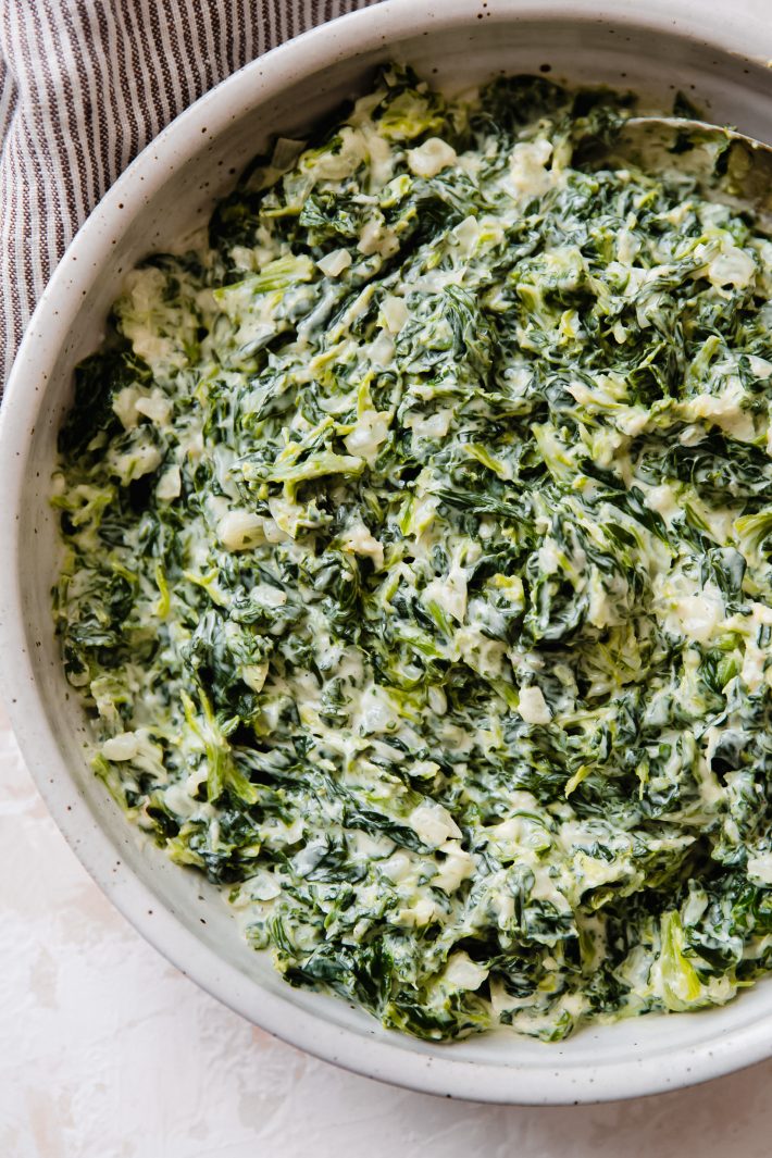 creamed spinach in speckled bowl
