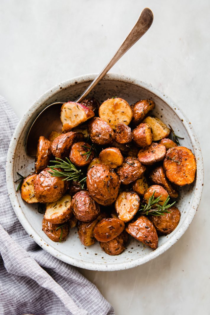 bowl of roasted potatoes with spoon