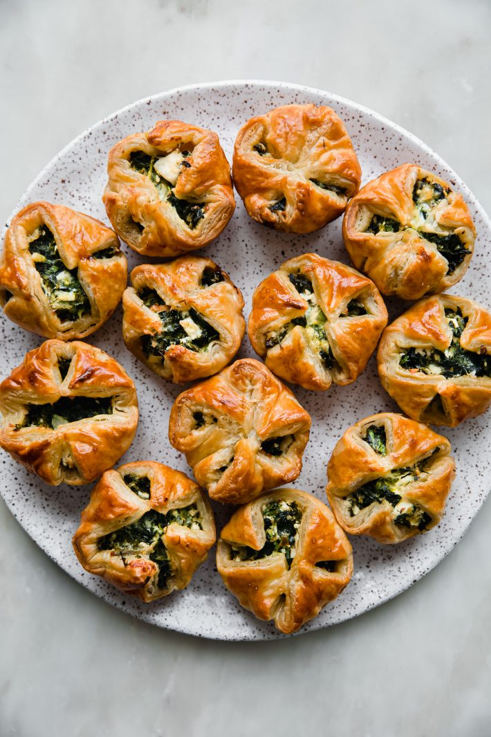 greek spinach puffs on a speckled plate