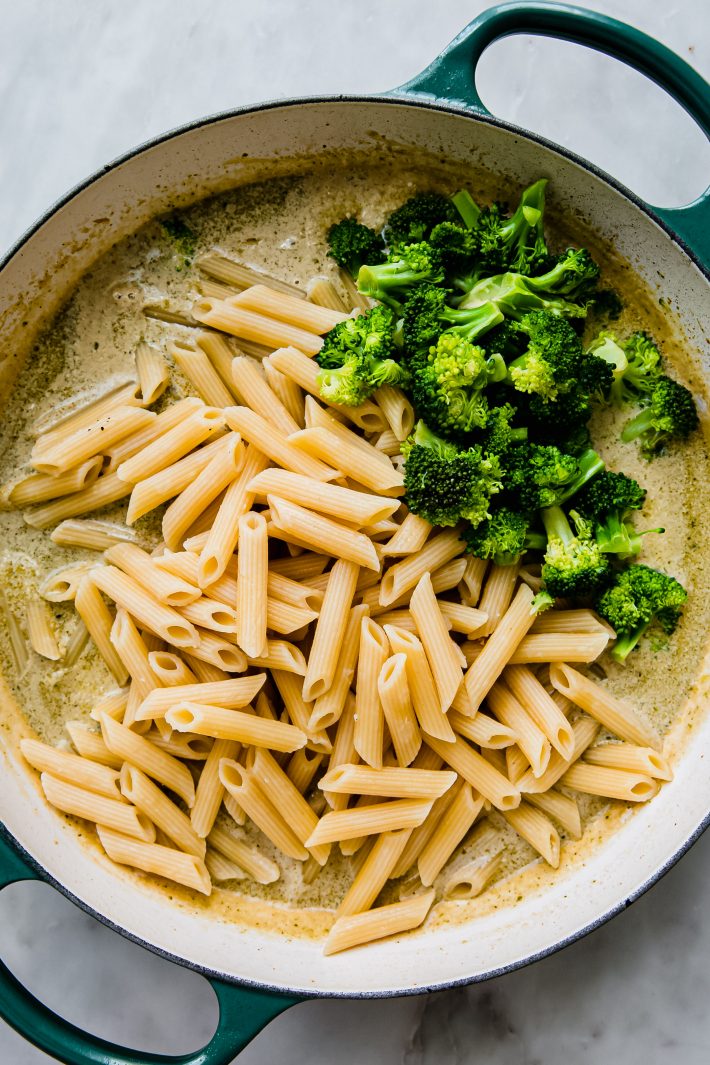 pesto cream sauce with prepared pasta and broccoli on top