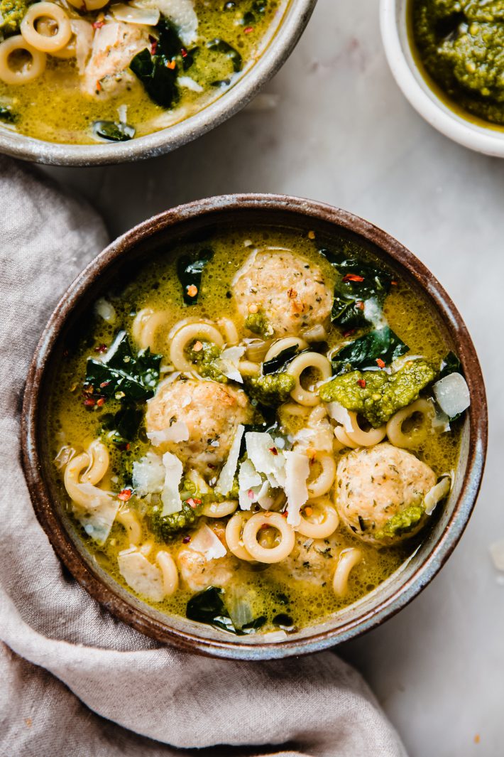 soup in bowl with parmesan and pesto on top