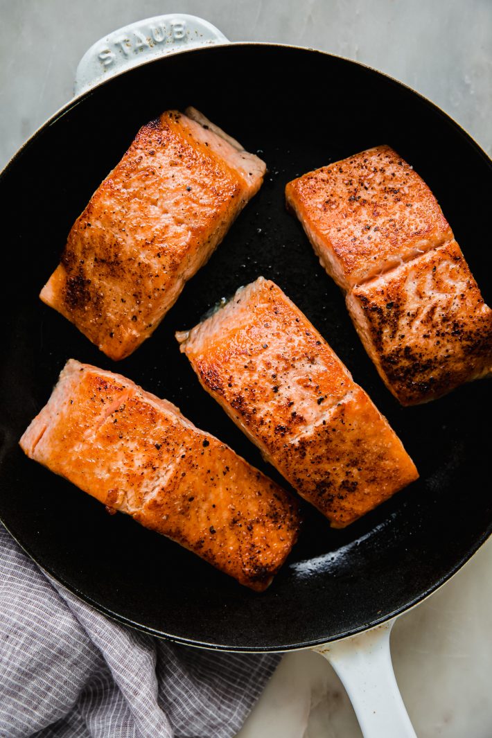 pan-fried salmon fillets in cast iron skillet