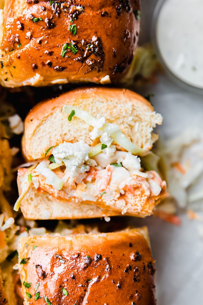 close up of buffalo chicken slider with blue cheese and ranch slaw