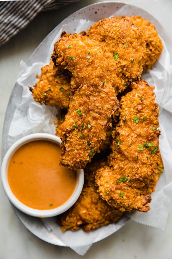chicken tenders on steel plate with sauce