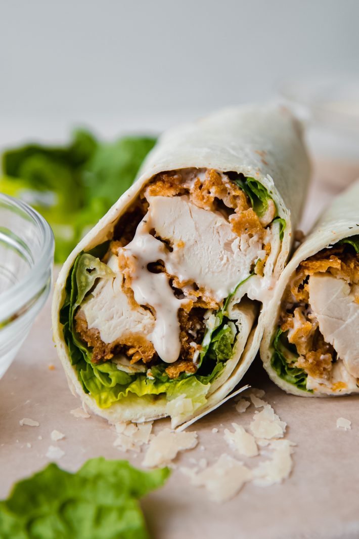 sliced chicken caesar wrap with dripping dressing