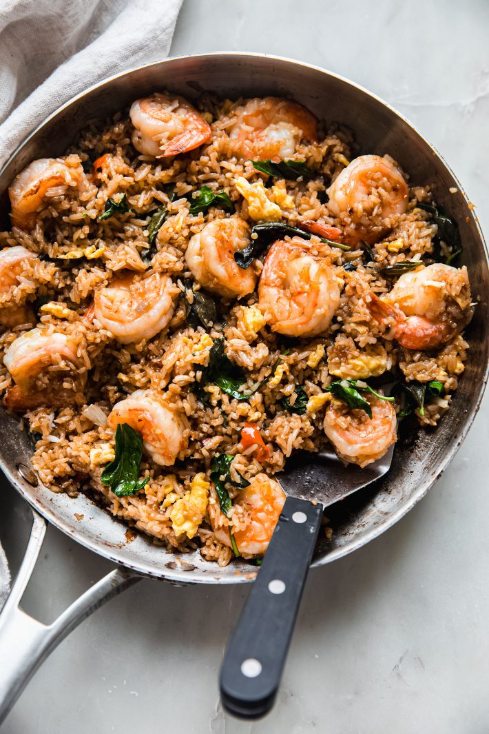 frying pan with fried rice and spatula