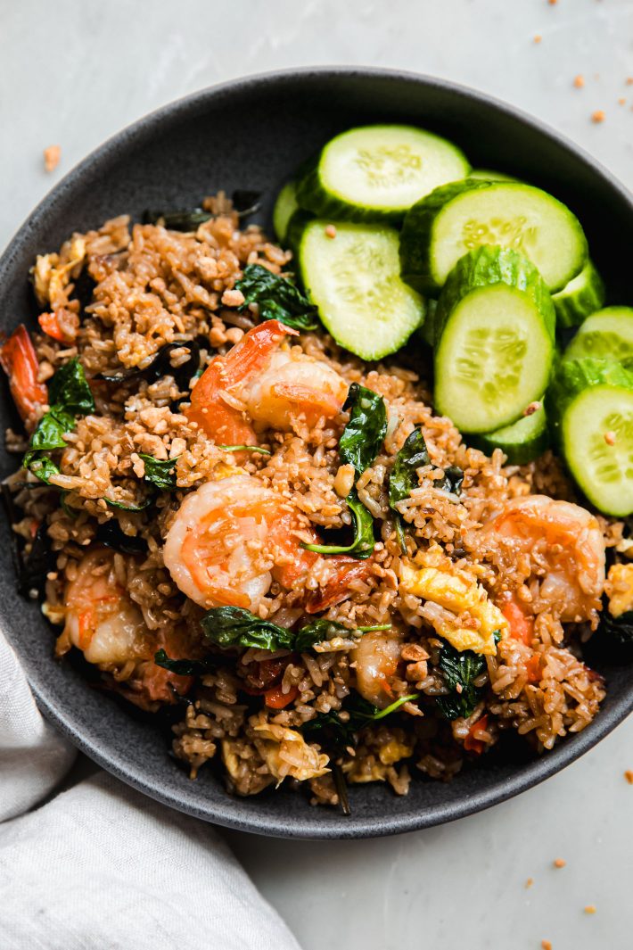 basil fried rice with shrimp in bow with cucumbers