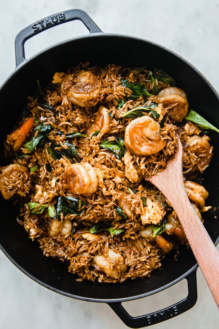 wooden spoon in dutch oven with fried rice