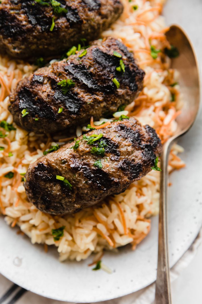 kafta on rice topped with parsley 