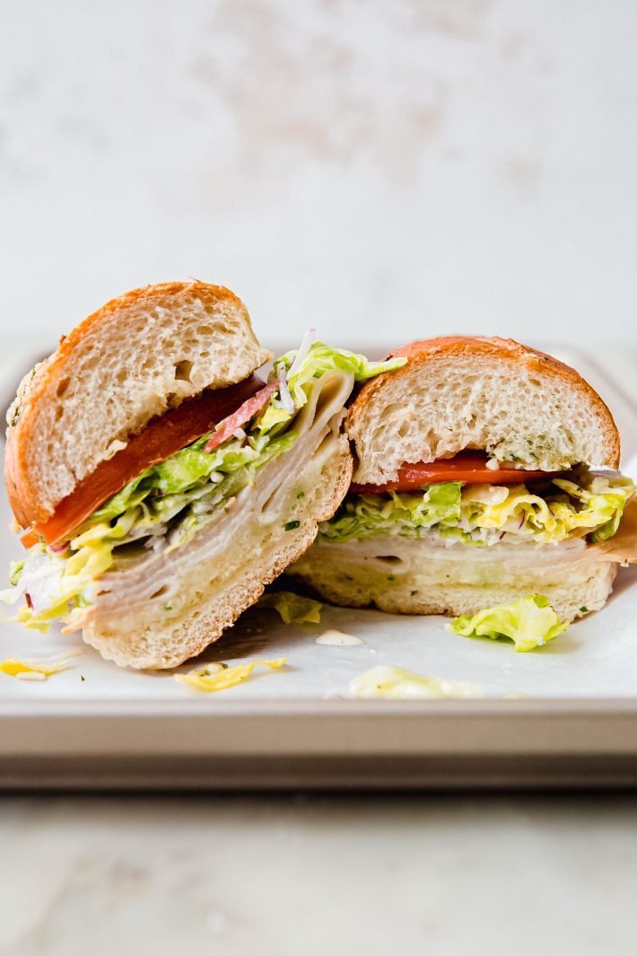 grinder salad sandwich halves on sheet pan