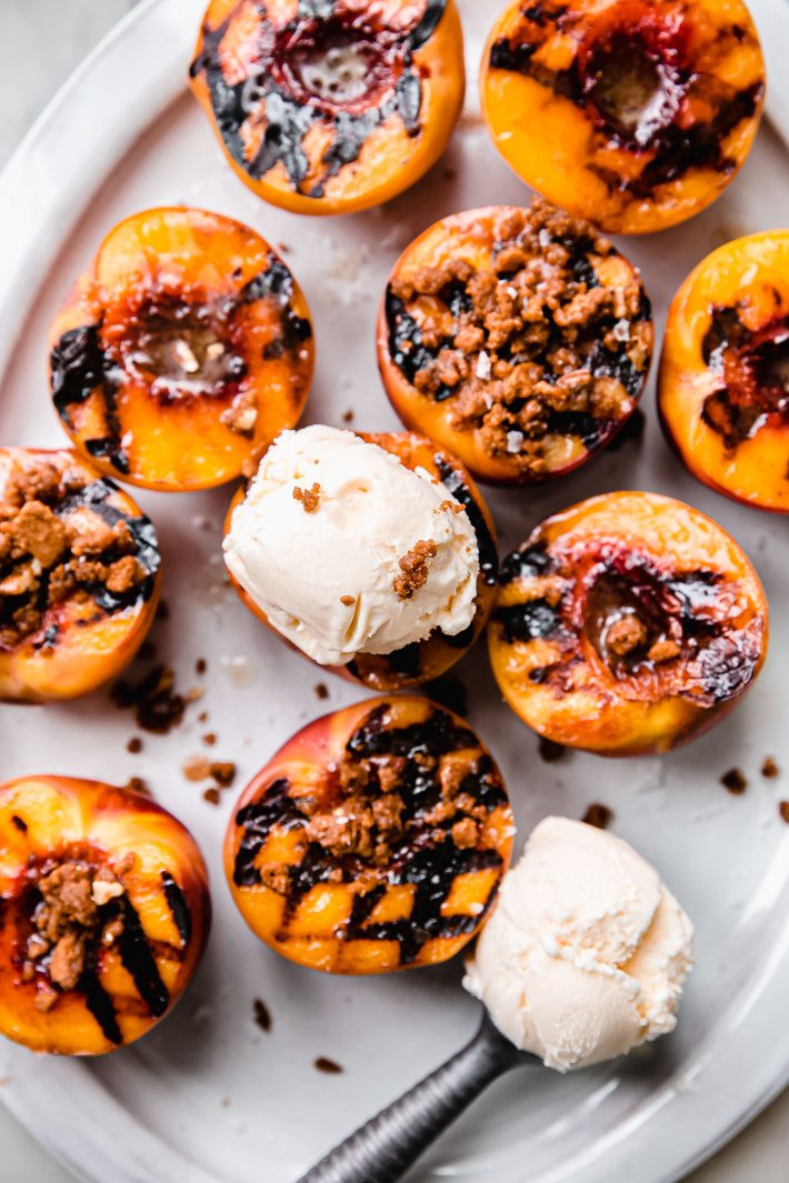 peaches topped with vanilla ice ream and crumble