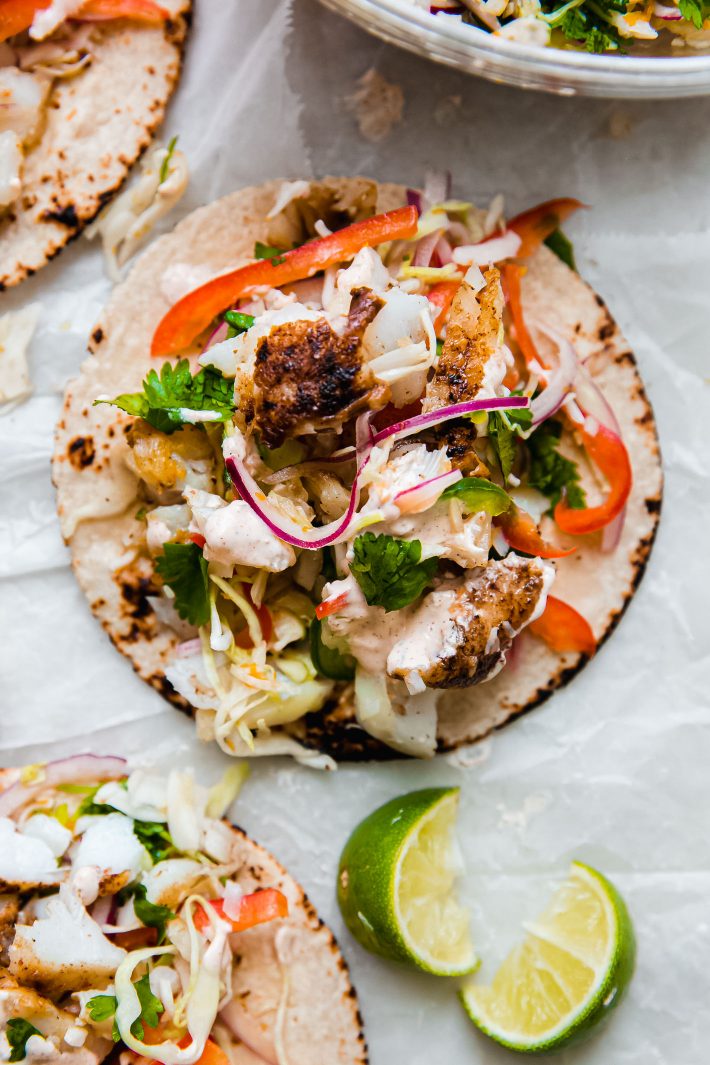 fish taco on parchment with slaw and chipotle sauce