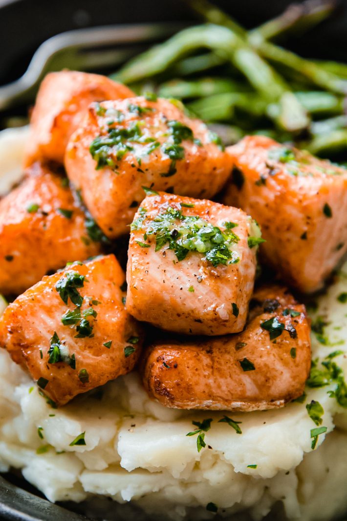 salmon bites topped with garlic butter and parsley