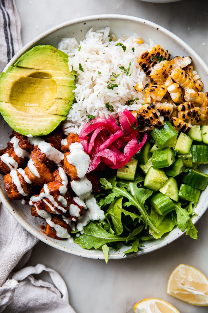 Cava bowl with honey harissa chicken and toppings