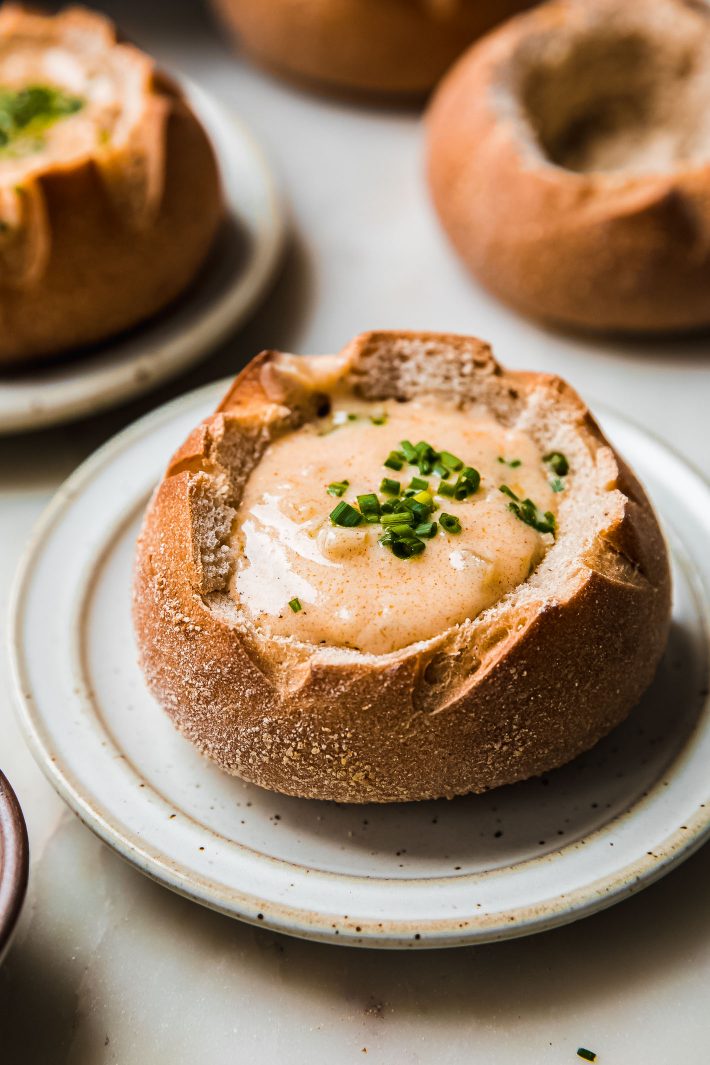smoked gouda soup in bread bowl with chives on top