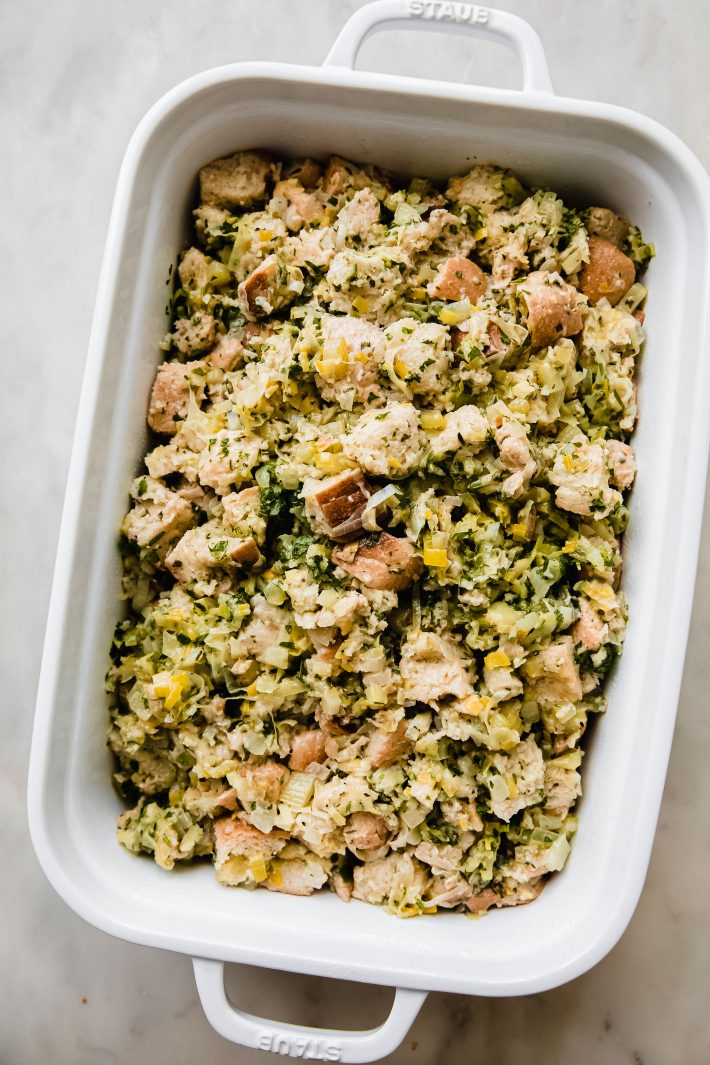 unbaked stuffing in white baking dish