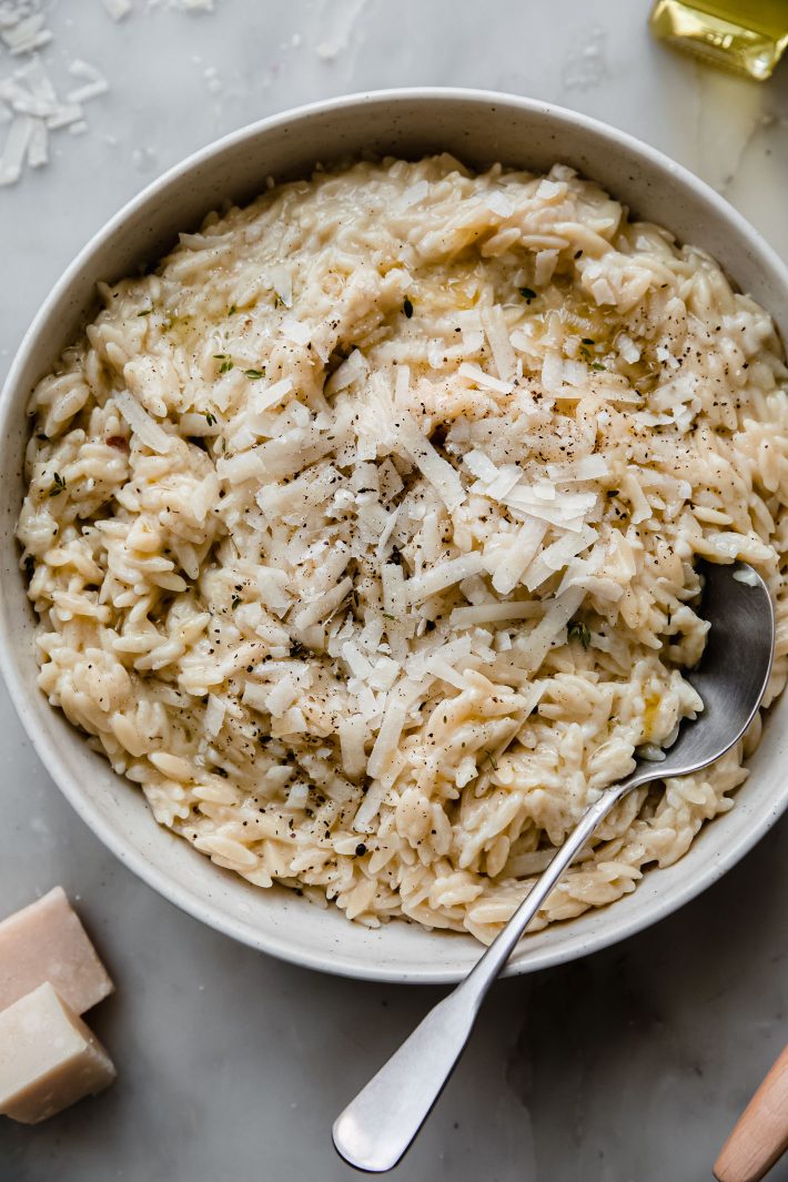 prepared risotto in bowl with metal spoon