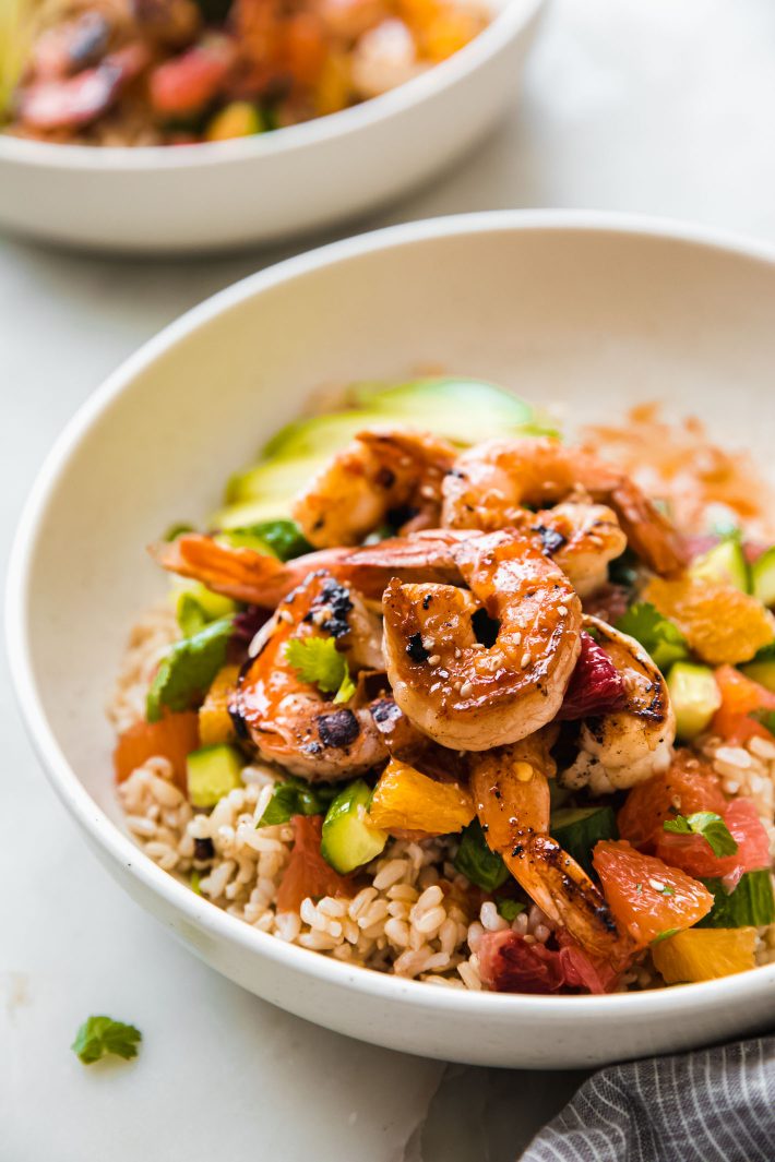 shrimp with sesame seeds over rice with citrus cucumber salad