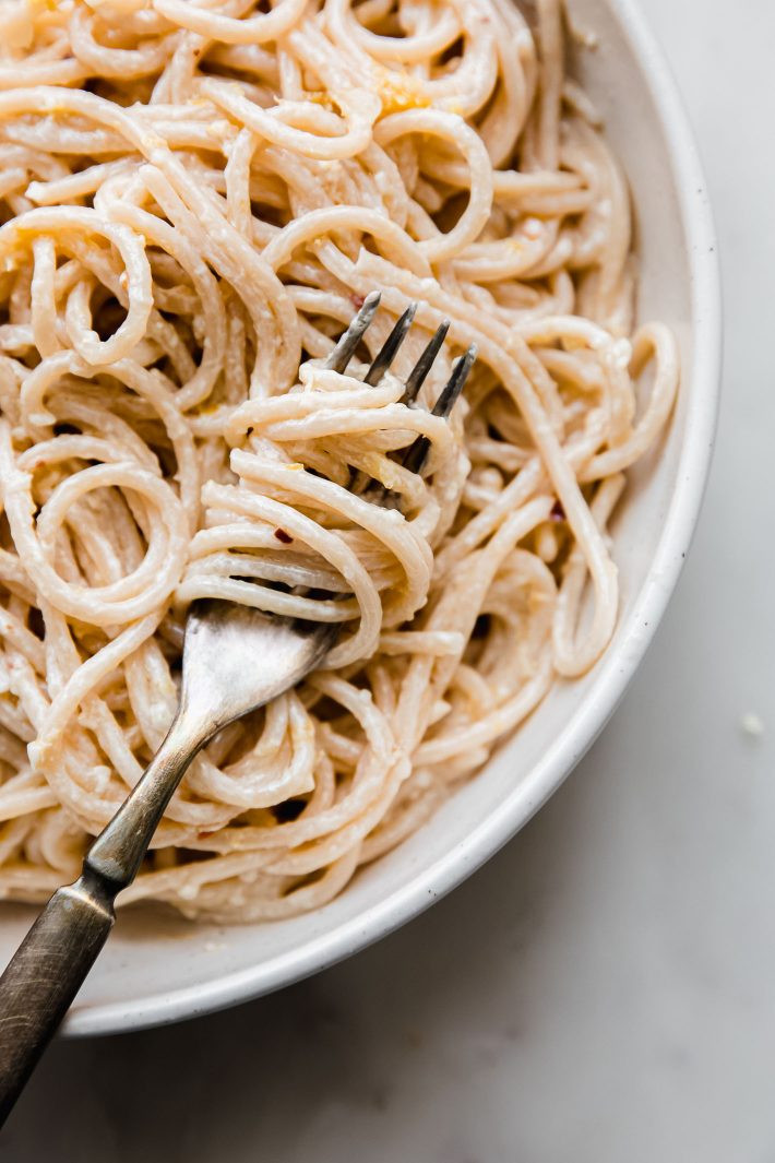 creamy lemon garlic pasta on fork in bowl