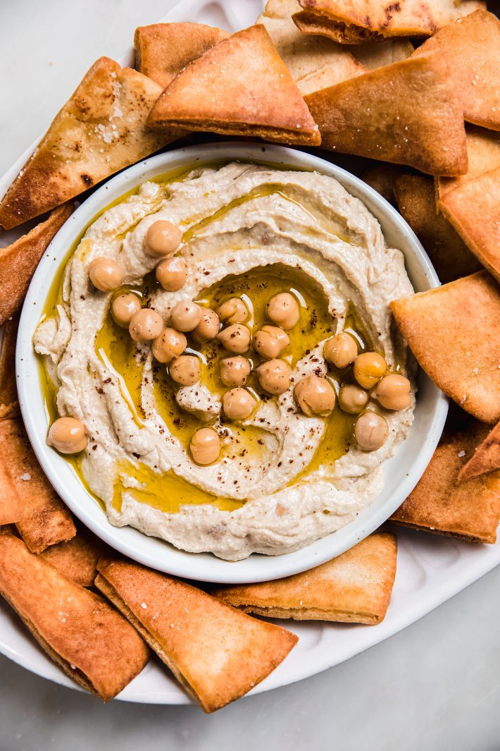 hummus topped with chickpeas with pita chips