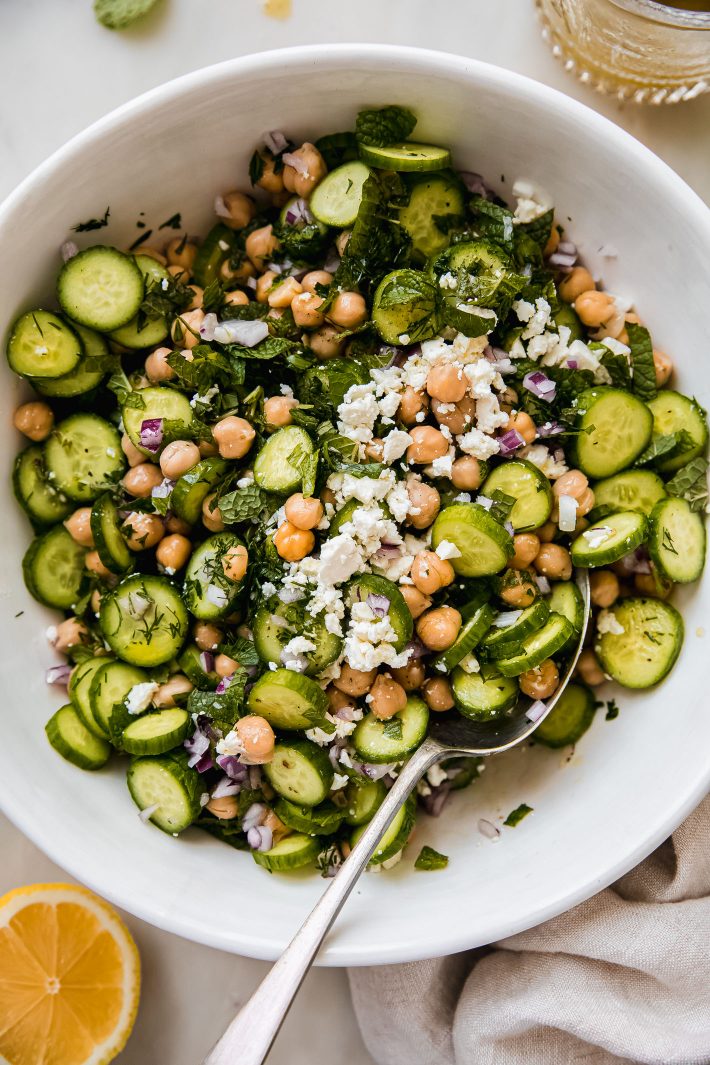 cucumber chickpea salad in bowl topped with feta cheese
