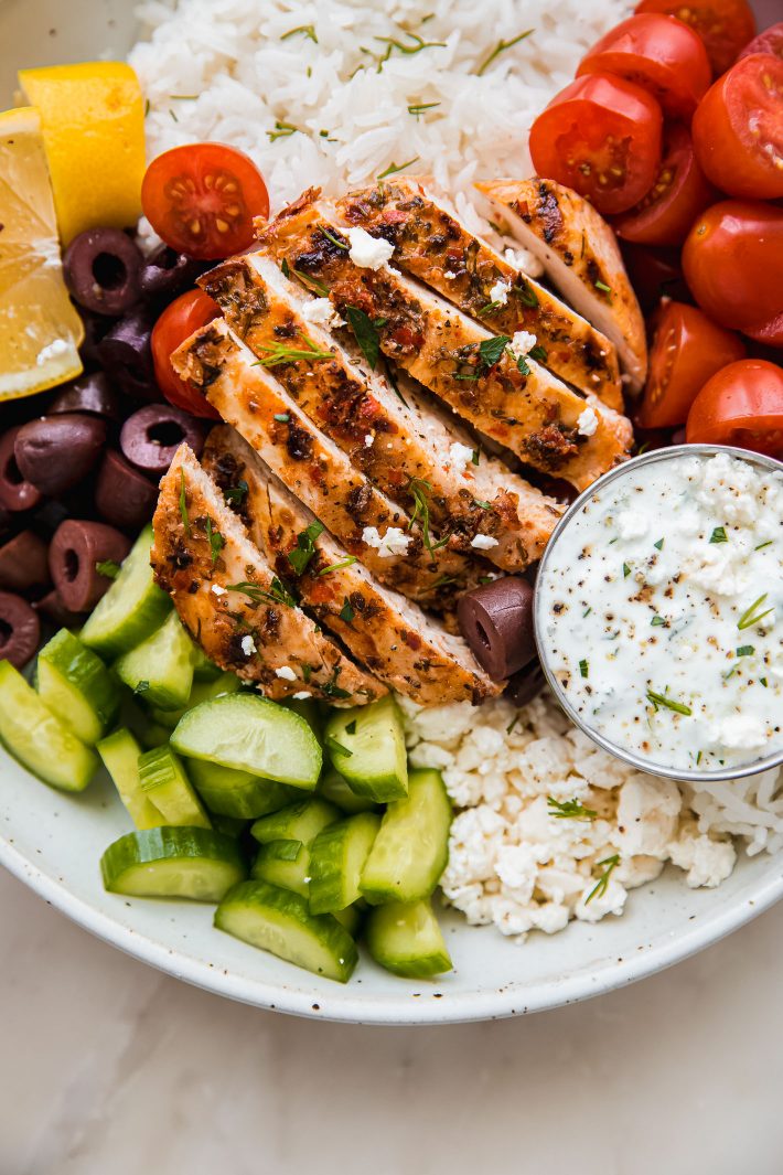 chicken tzatziki bowls topped with cucumbers, feta, olives, and tomatoes