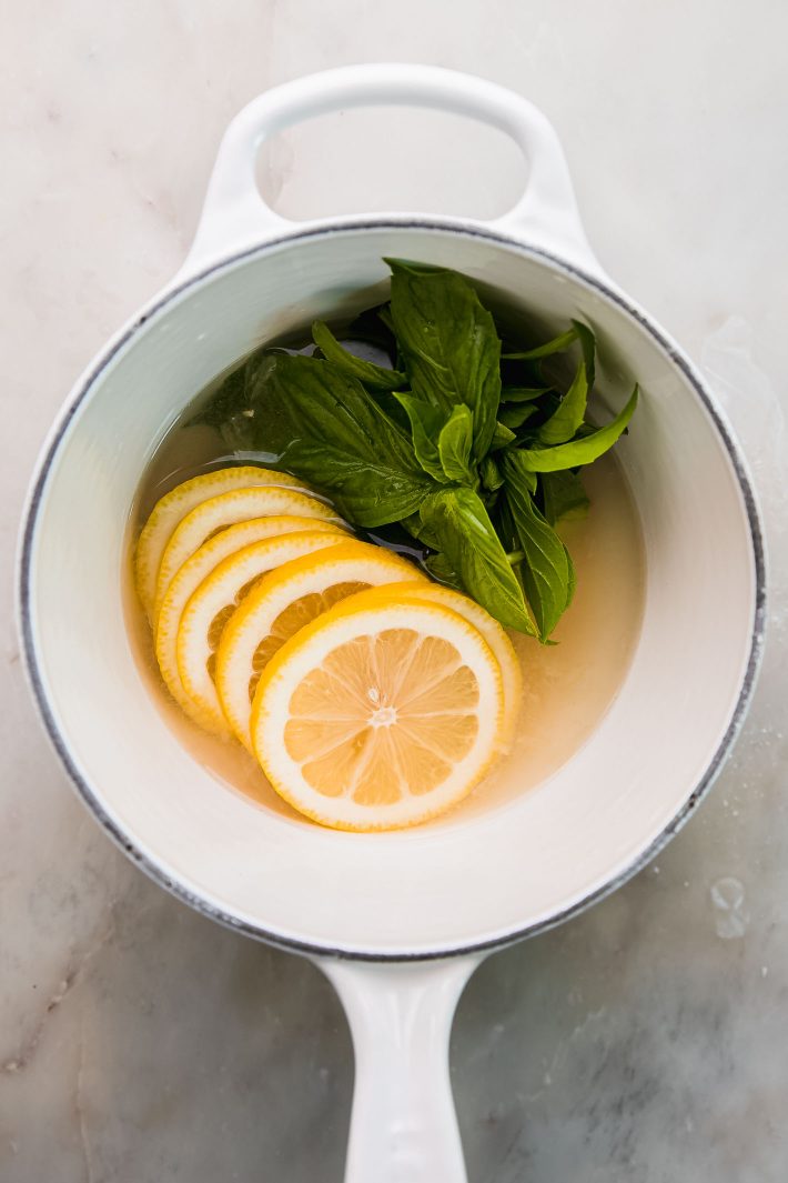 lemon basil simple syrup in saucepan