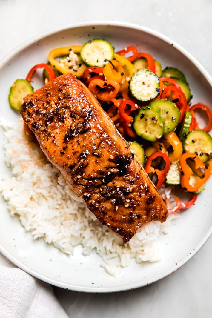 chili crunch salmon with cucumber salad and rice in bowl