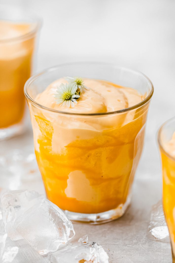 cup drizzled with mango pulp and blended drink