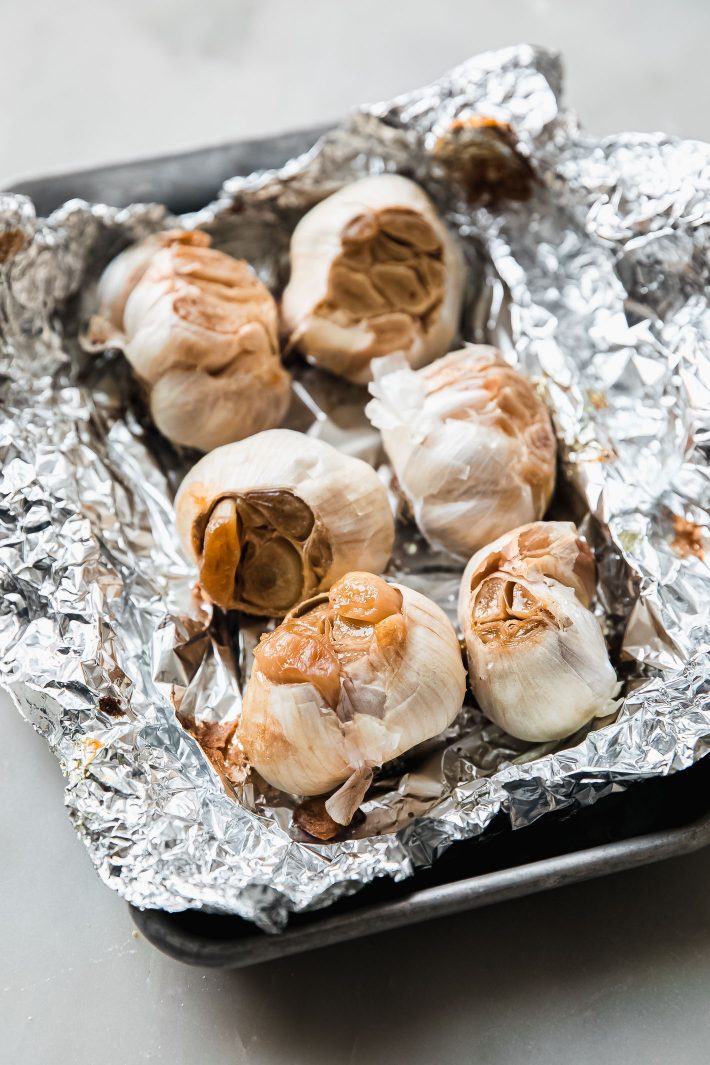 roasted garlic on on foil and sheet pan