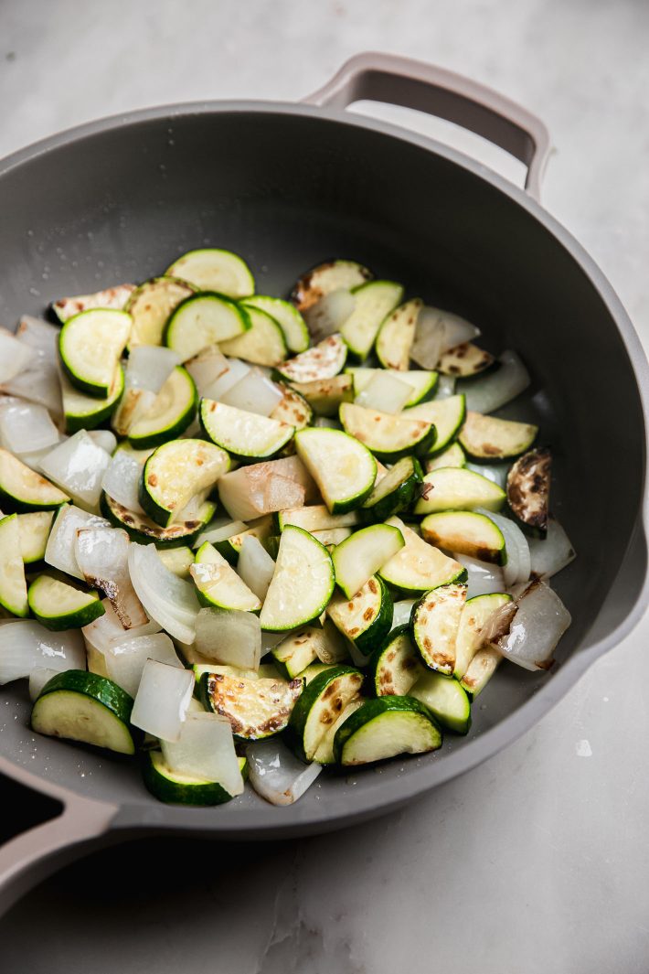 zucchini and onions in pan after sautéing