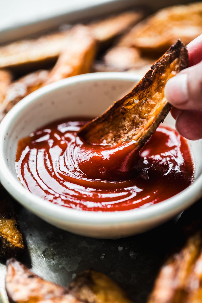 potato wedges dipped in ketchup