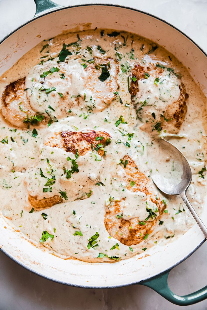 cast iron pan with cilantro lemon creamy sauce and chicken